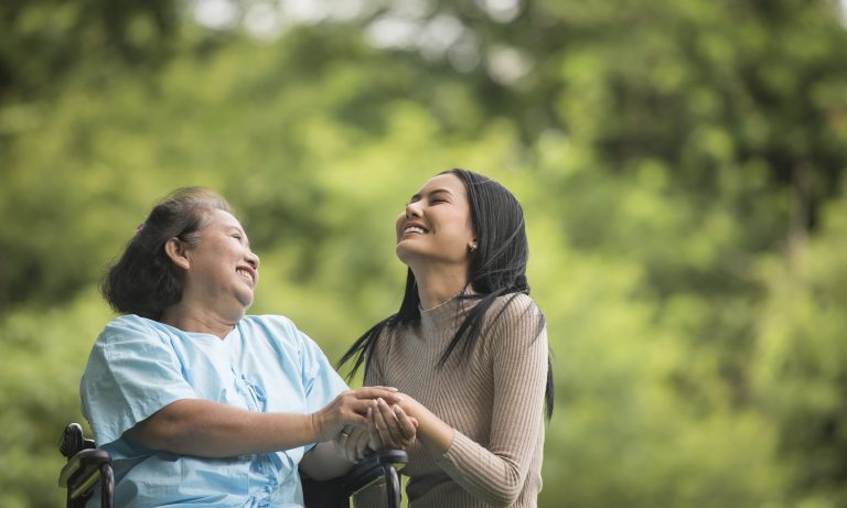 granddaughter-talking-with-her-grandmother-sitting-wheelchair-cheerful-concept-happy-family