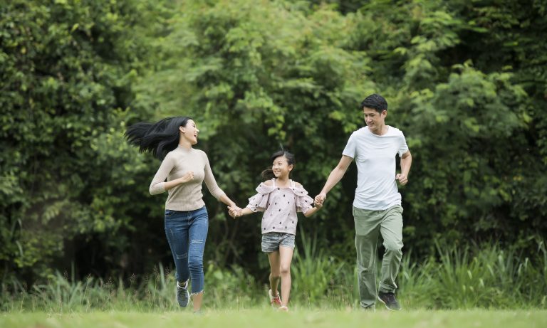 happy-family-is-having-fun-mother-father-daughter-are-running-park