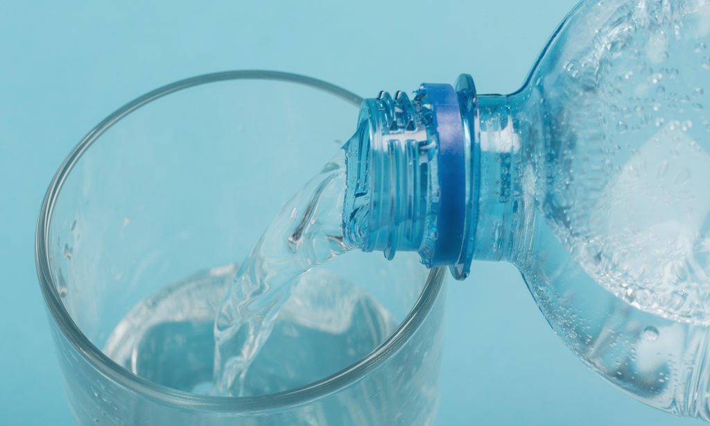 high-view-pouring-sparkling-water-glass